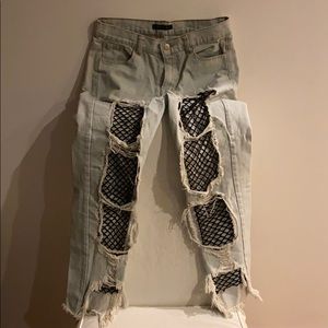 Light wash denim jeans with fishnet rips
